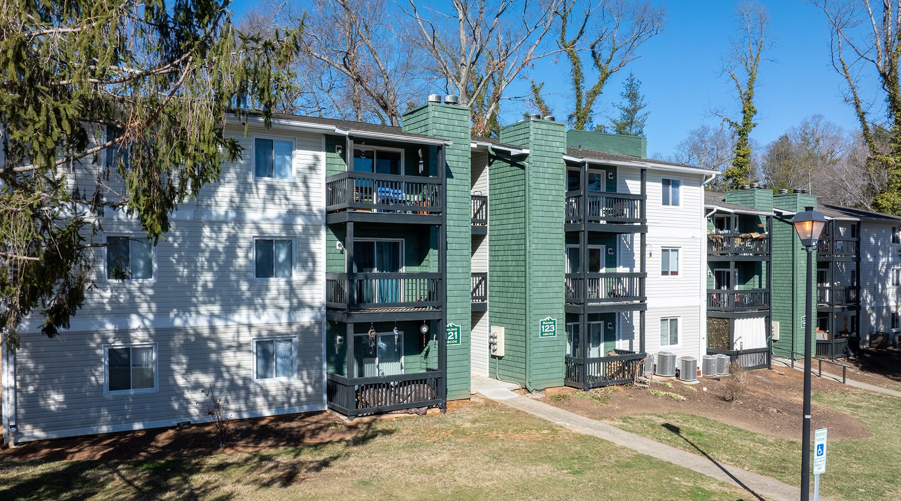 Live Beautifully wide shot of apartment building and walkways at Manor Ridge Apartments