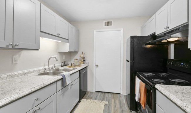 kitchen with grey cabinets and black appliances