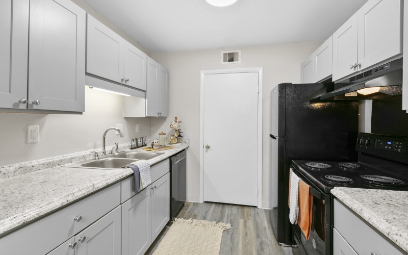 kitchen with grey cabinets and black appliances