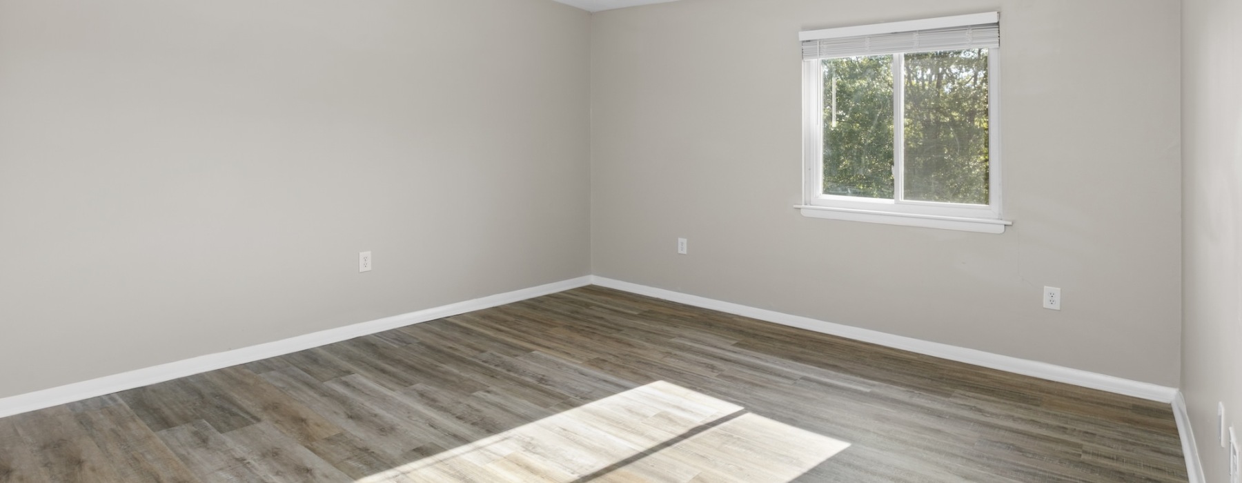 bedroom with wood floor and windows