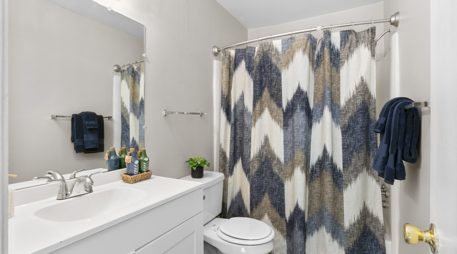a bathroom with a tub toilet sink and mirror